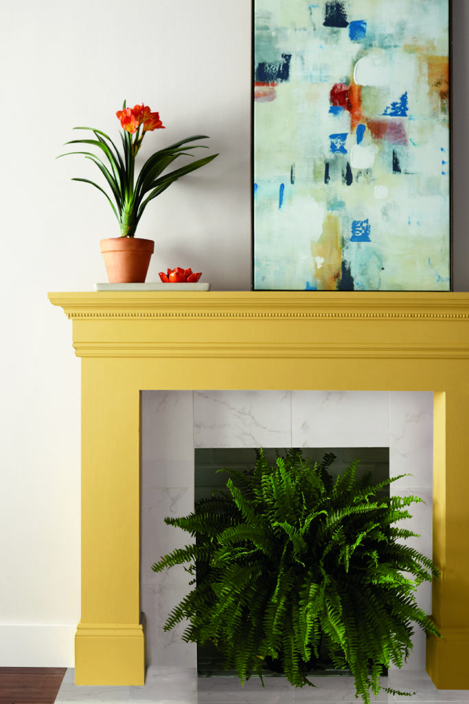 A fireplace painted in a vibrant yellow color.