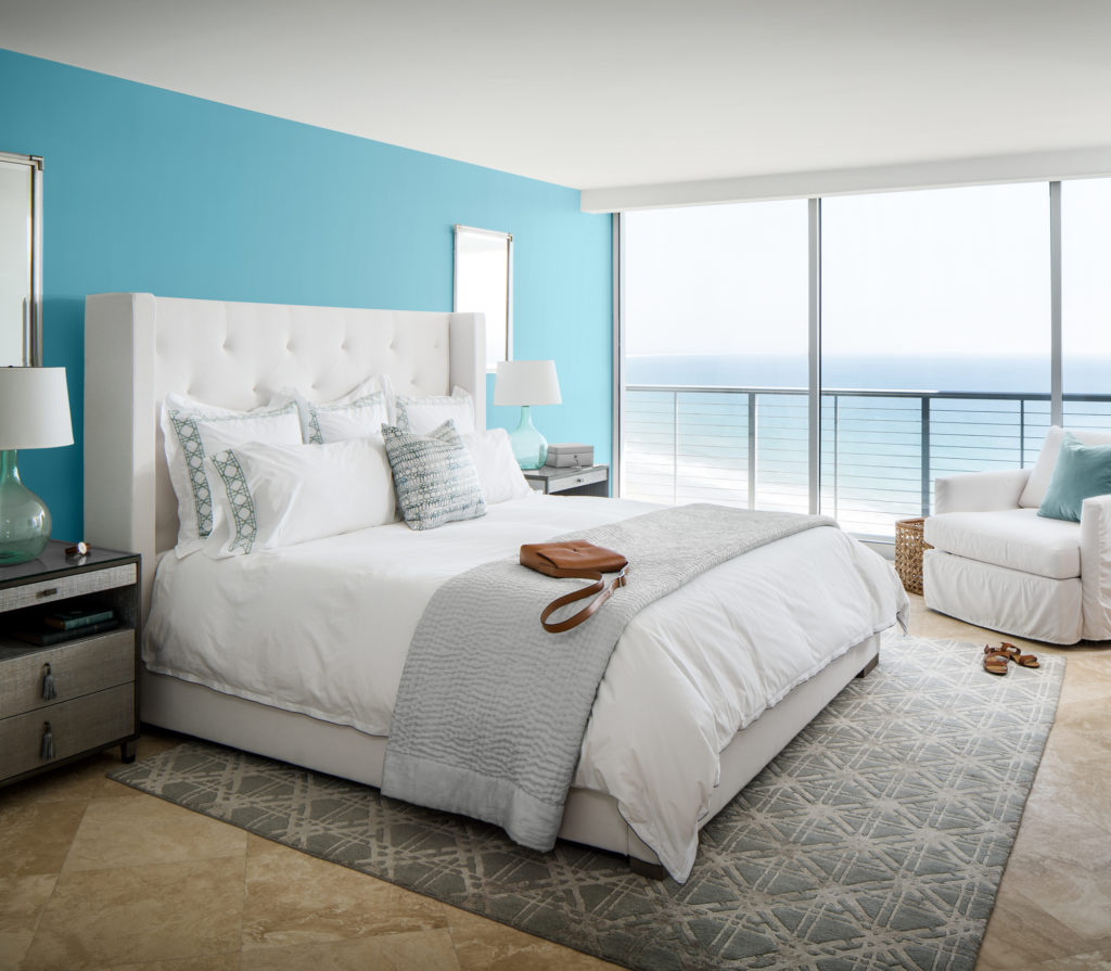 A beautiful bedroom painted is blue color called Explorer Blue.  The room has an amazing ocean view.   