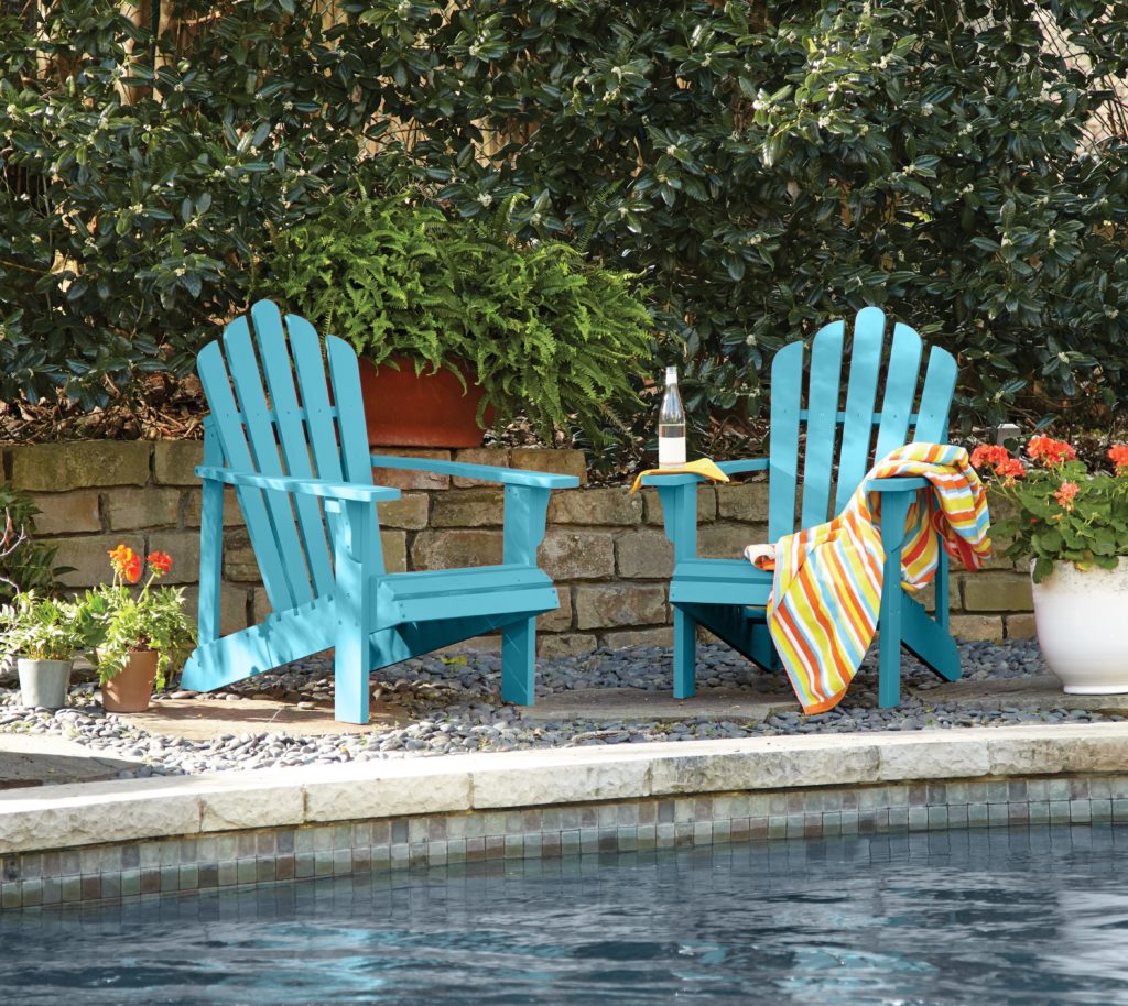 Two adirondack chairs staged by the poolside.  The chairs feature a fun, summer hue called Explorer Blue. 