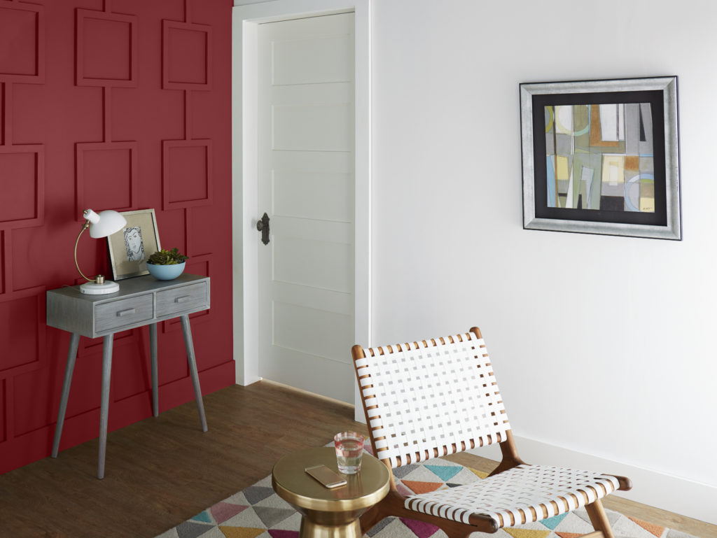 Seating area with accent wall in Dark Crimson which is a deep red burgundy hue. 