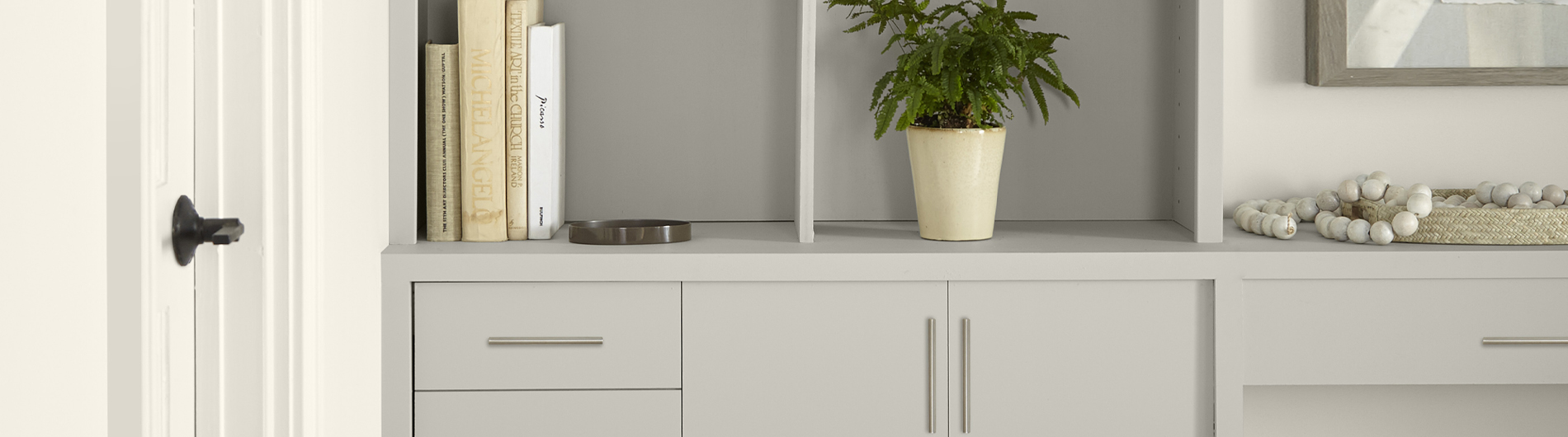 Built-in cabinet with open shelving painting in the color Gratifying Gray.