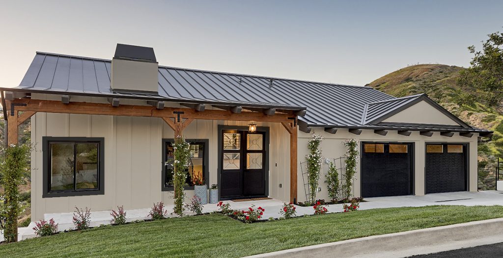 Front photo of a small modern farmhouse exterior at sunset. The body of the house is painted with Even Better Beige and the all trim, front and garage doors are painted in BLACK. 