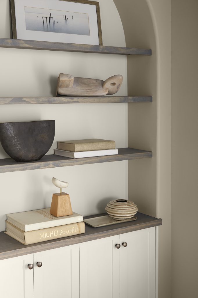 Built-in shelves in a home office, the walls are painted in  Even Better Beige and back of the shelves is painted in color of the year, Blank Canvas. 