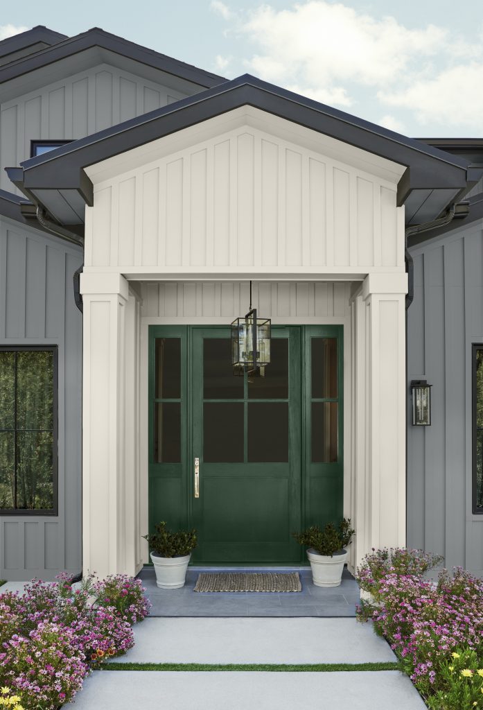 The exterior front door and entry of modern farmhouse, the door is painted in dark green color called Vine Leaf. 