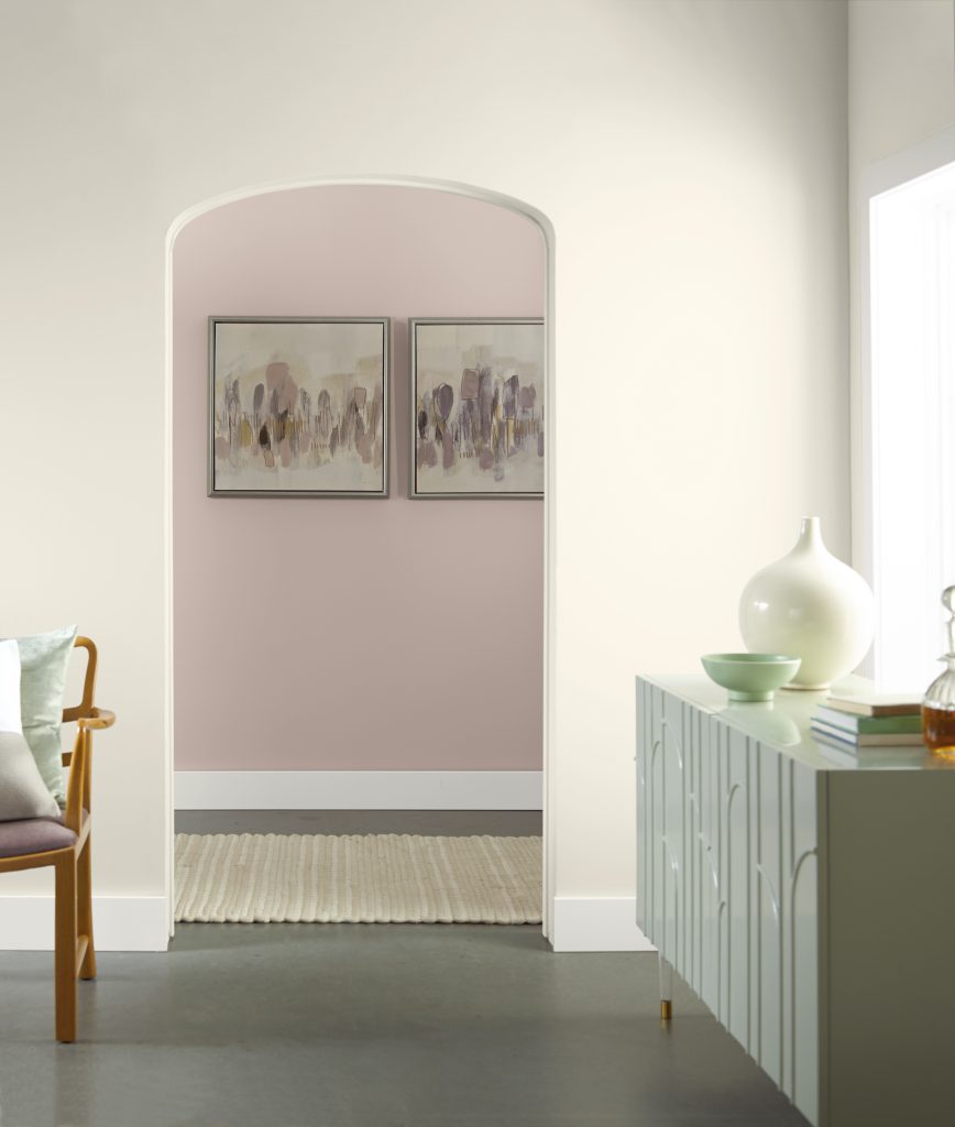 A living room area and a hallway showcasing a pink color called Smokey Pink.  A light green console is placed on the foreground.