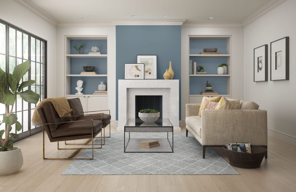 A contemporary living room with a fireplace and built-in shelves.  Adirondack Blue is used for the accent wall. The neutral color furniture and pops of color found on the decorative elements coordinate nicely with Adirondack blue. 