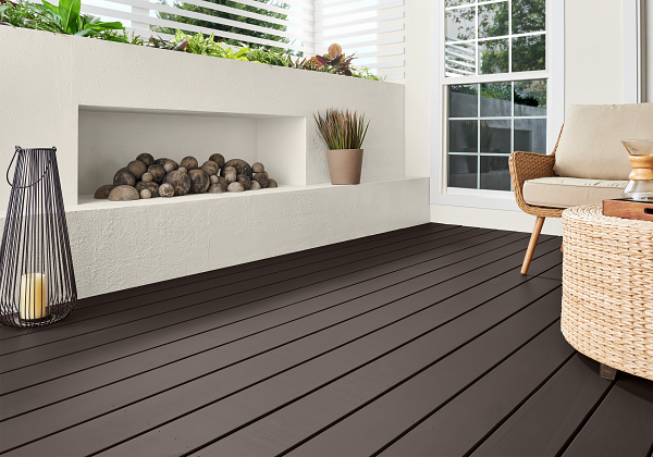 The deck of a white modern home exterior featuring the solid version of Cordovan Brown. 