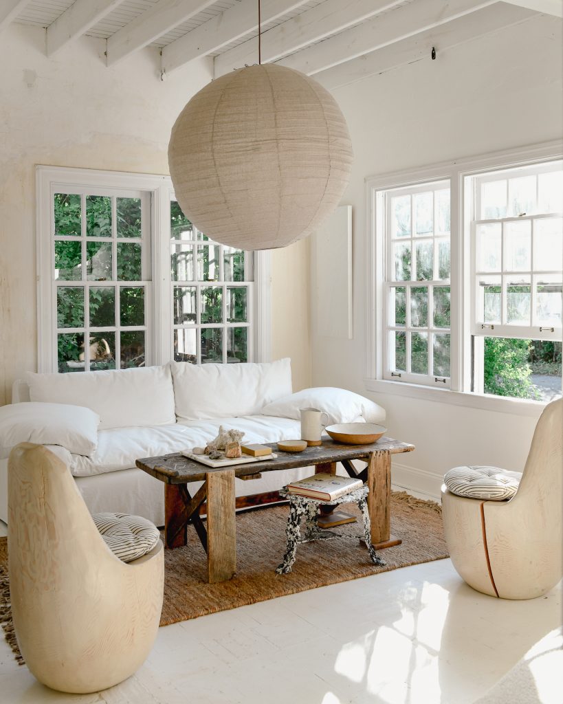 A living room with white painted walls and white furniture.