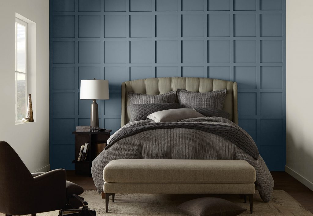 A casual bedroom featuring an accent painted with Adirondack Blue.