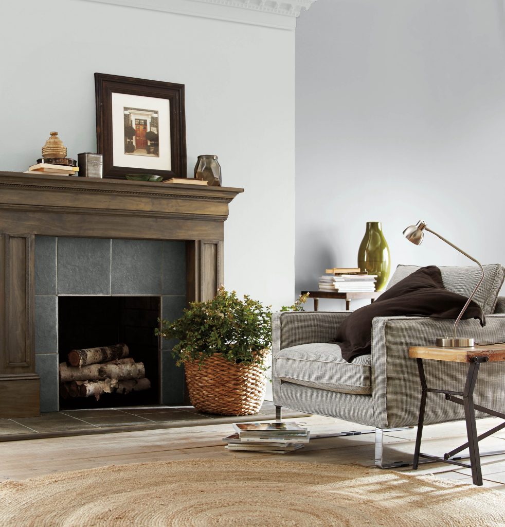 A timeless living room with a fireplace, the color featured on the walls is  a one of BEHR's most popular grays, French Silver.