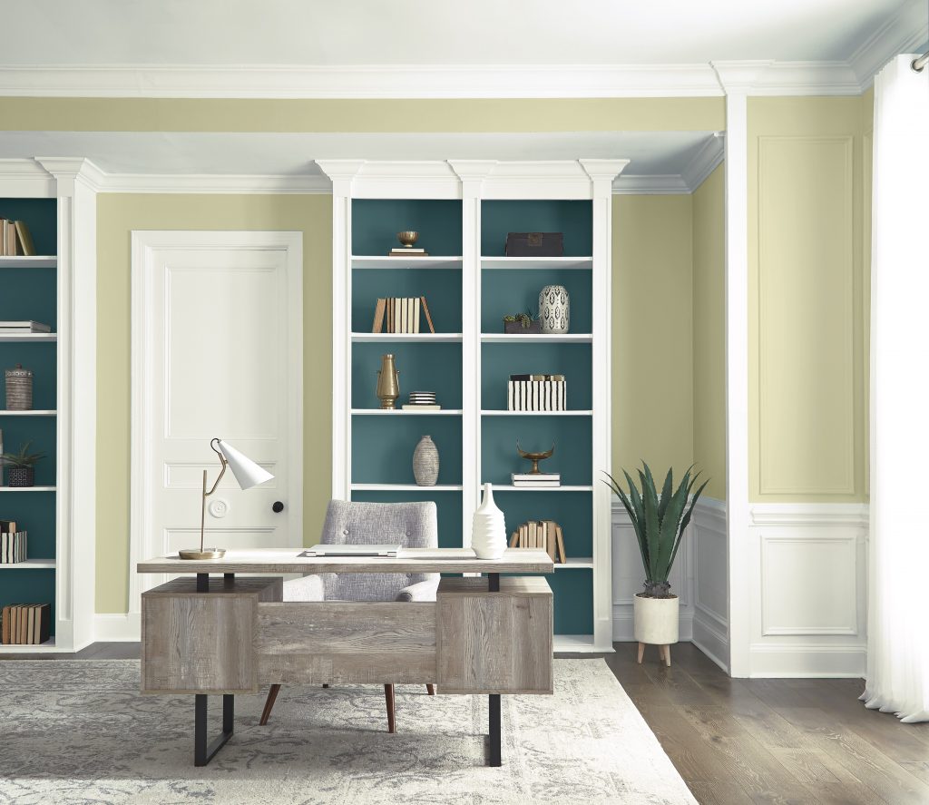 A updated traditional home office with built-in shelves.  The is wainscoting and trim and molding throughout the room. 
The walls are painted with Hybrid and the back of the shelves are painted with an accent color called Sophisticated Teal.  