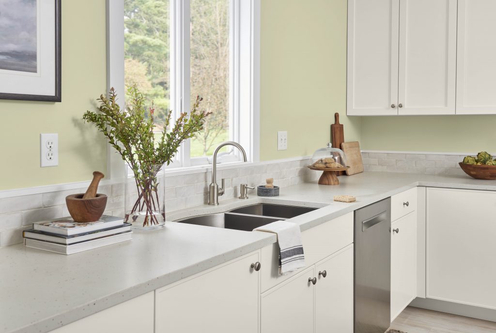 A casual home kitchen, the color on the walls is a muted pastel yellow-green called Hybrid. 