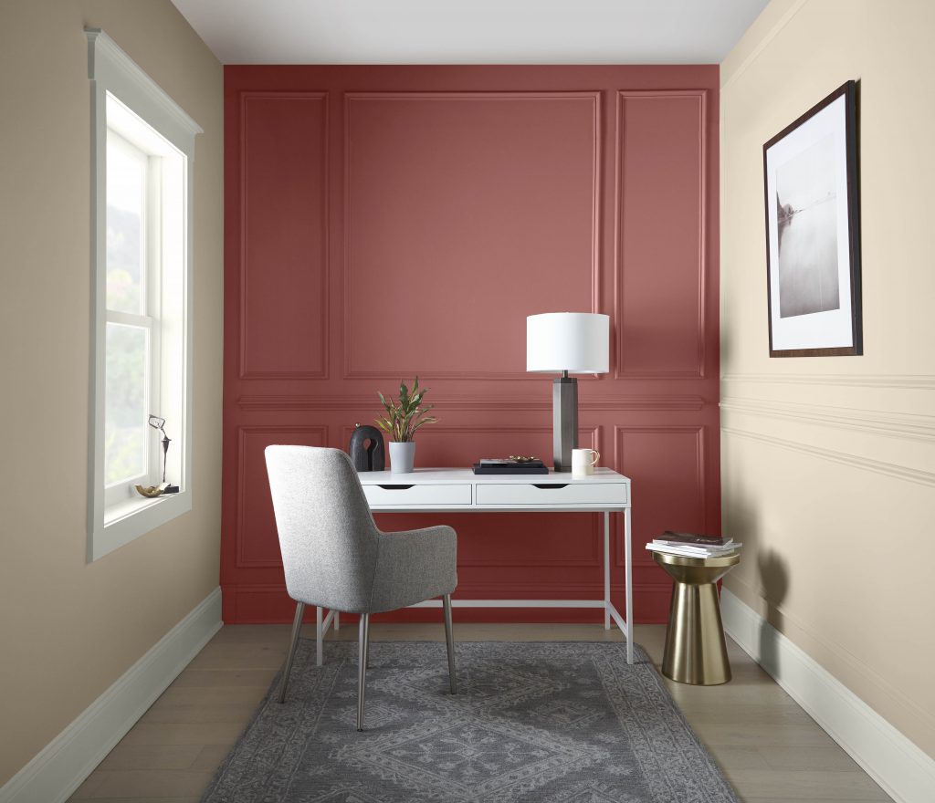 A new traditional home office space, the walls have a lot of of molding detail and there is an accent wall featuring a red color called Vermilion.  
