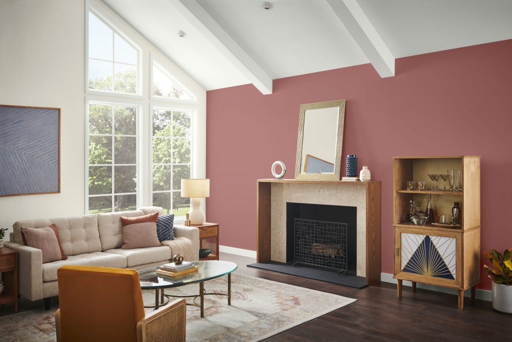 A mid century modern living room with some Art Deco décor elements.  The fireplace on the right side of the room is featuring an accent color called Vermilion. 