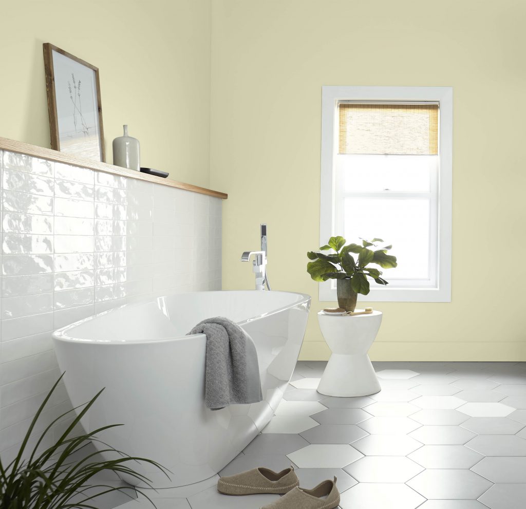A Spa like bathroom with a large window. There is white tile and a large modern bathtub. The color on the walls is Hybrid. 