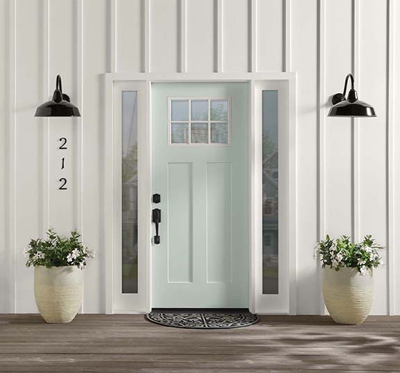 A home showing the front door painted in a minty green hue.