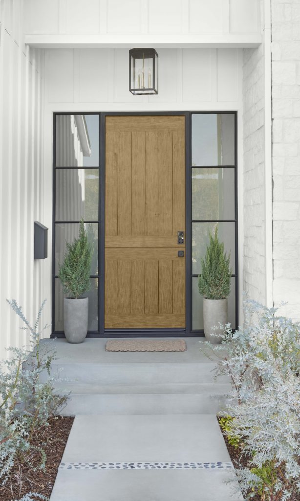 A home showing the front door stained in a light wood color.