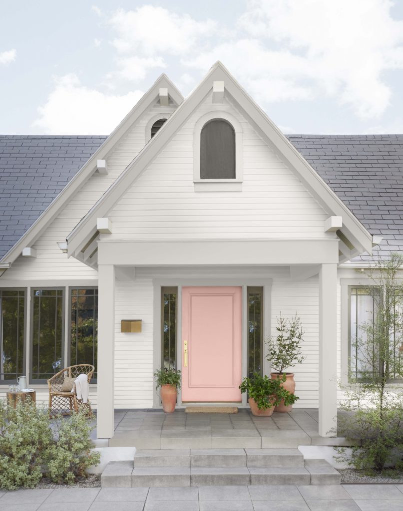 A home showing the front door painted in a pink hue.