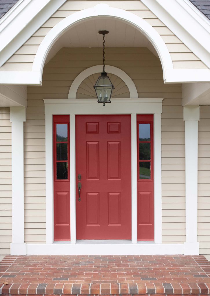 A home showing the front door painted in a red hue.