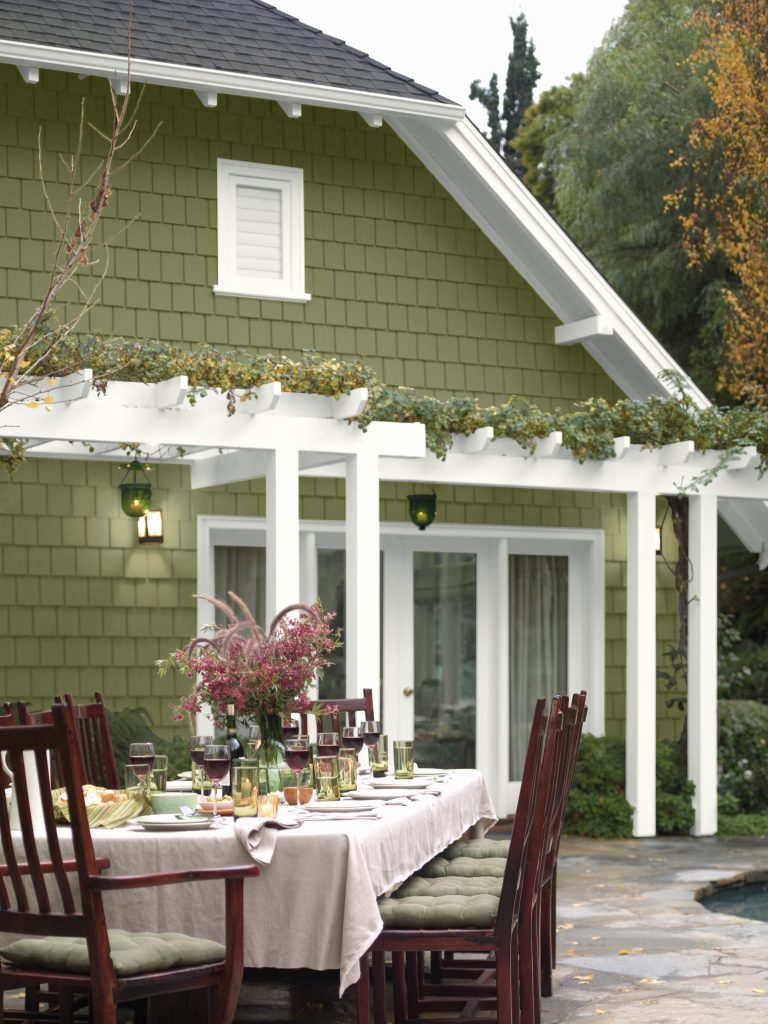 An exterior of a home painted in a green hue.