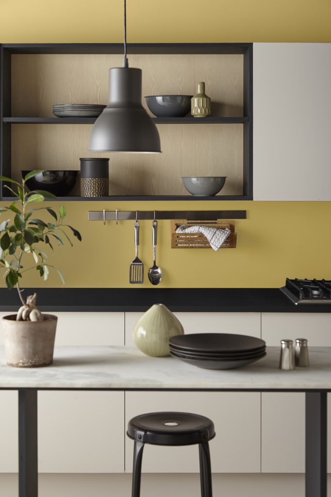 A kitchen with the walls painted in a yellow tone.