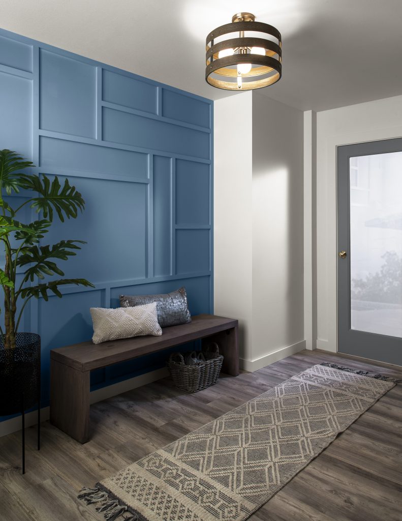 An interior entry with an accent wall painted in a deep blue hue.