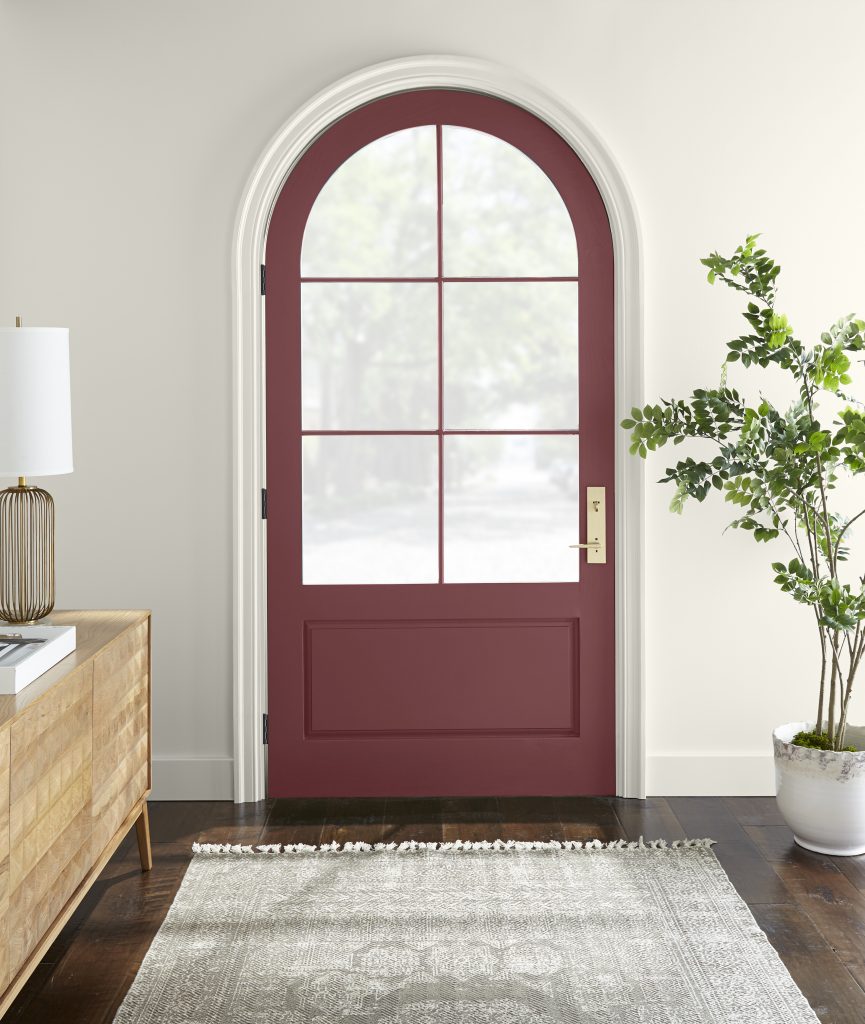 An interior homes entry with a red painted front door.