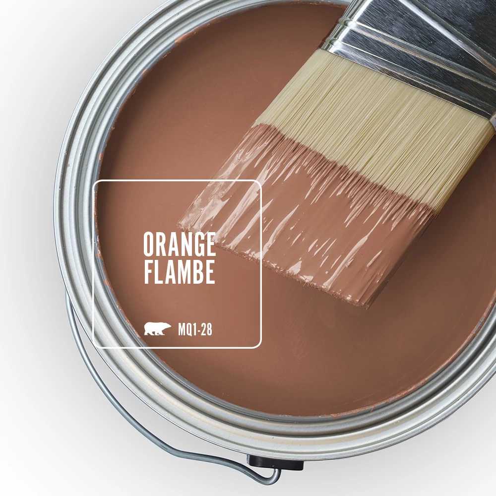 The top view of an open paint can, there is a half-dipped paint brush and the feature color of Orange Flambe. 