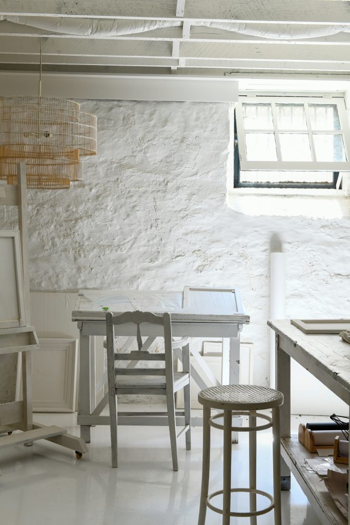 A work area with a small desk in the basement.