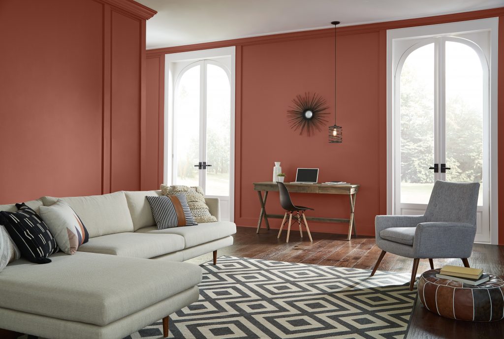 A living room with warm red painted walls.