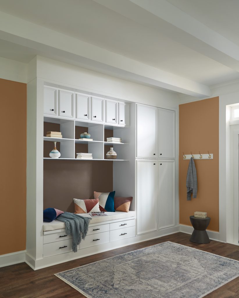An entryway with a closet area and a bench.