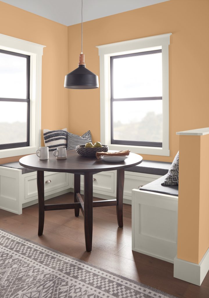 A kitchen nook with the walls painted in a soft orange hue.