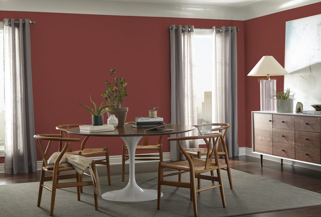Dining Room walls painted in Red Pepper PPU2-02. Chairs, table and mid-century modern dresser. 