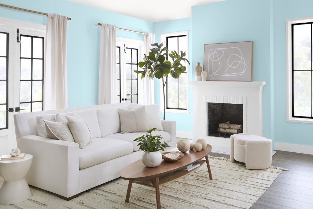 A living room painted in a soft but bright room with all white furnishings.