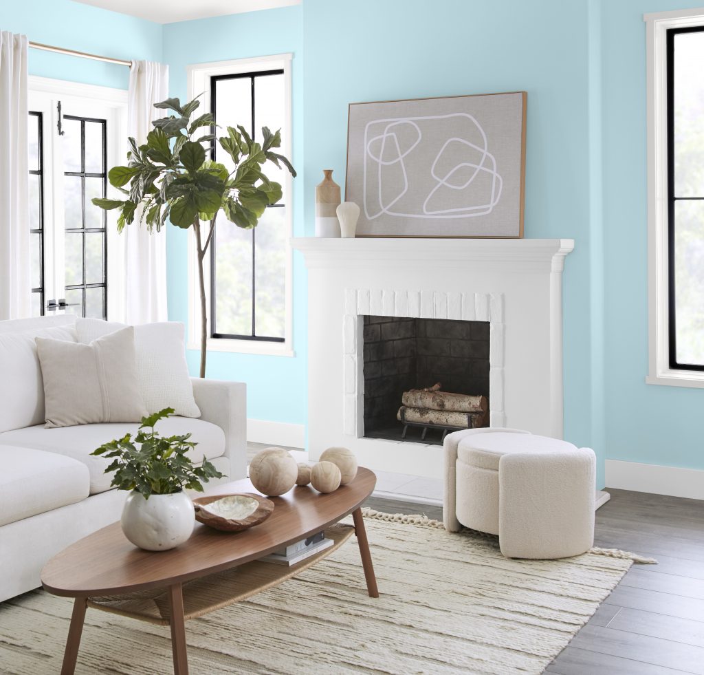 A tight crop of a living room painted in a soft but bright room with all white furnishings.