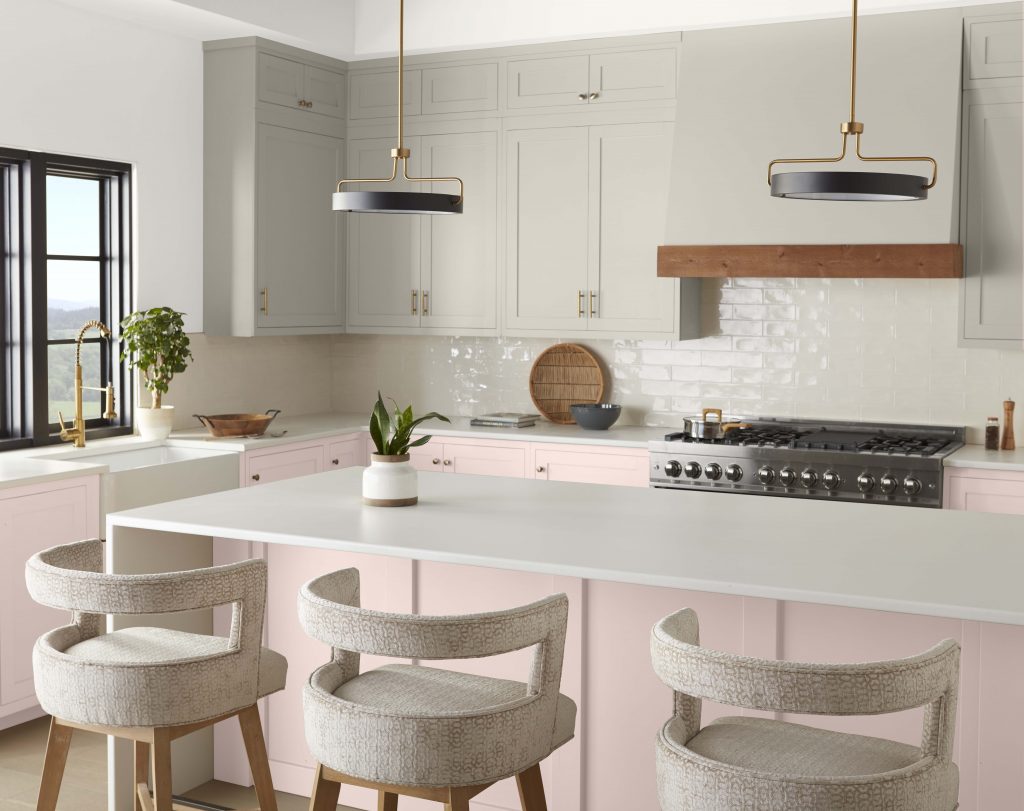 A contemporary kitchen with an unexpected color combination, gray cabinets and light pink walls.  
