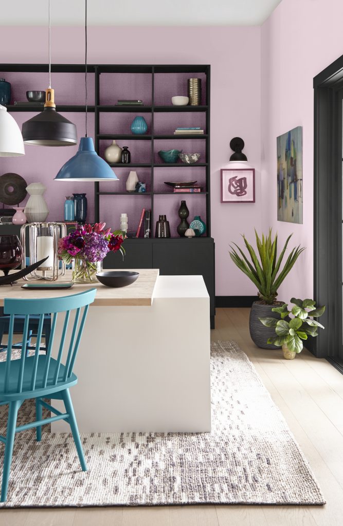 Dining area with build-in cabinets painted in a black hue with walls and accents in pink-lavender color.