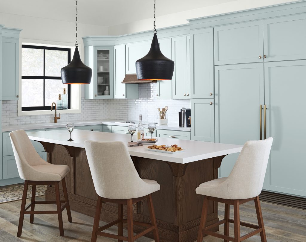 A modern chic kitchen with all blue cabinetry, the paint color used on the cabinets is Offshore Mist. 