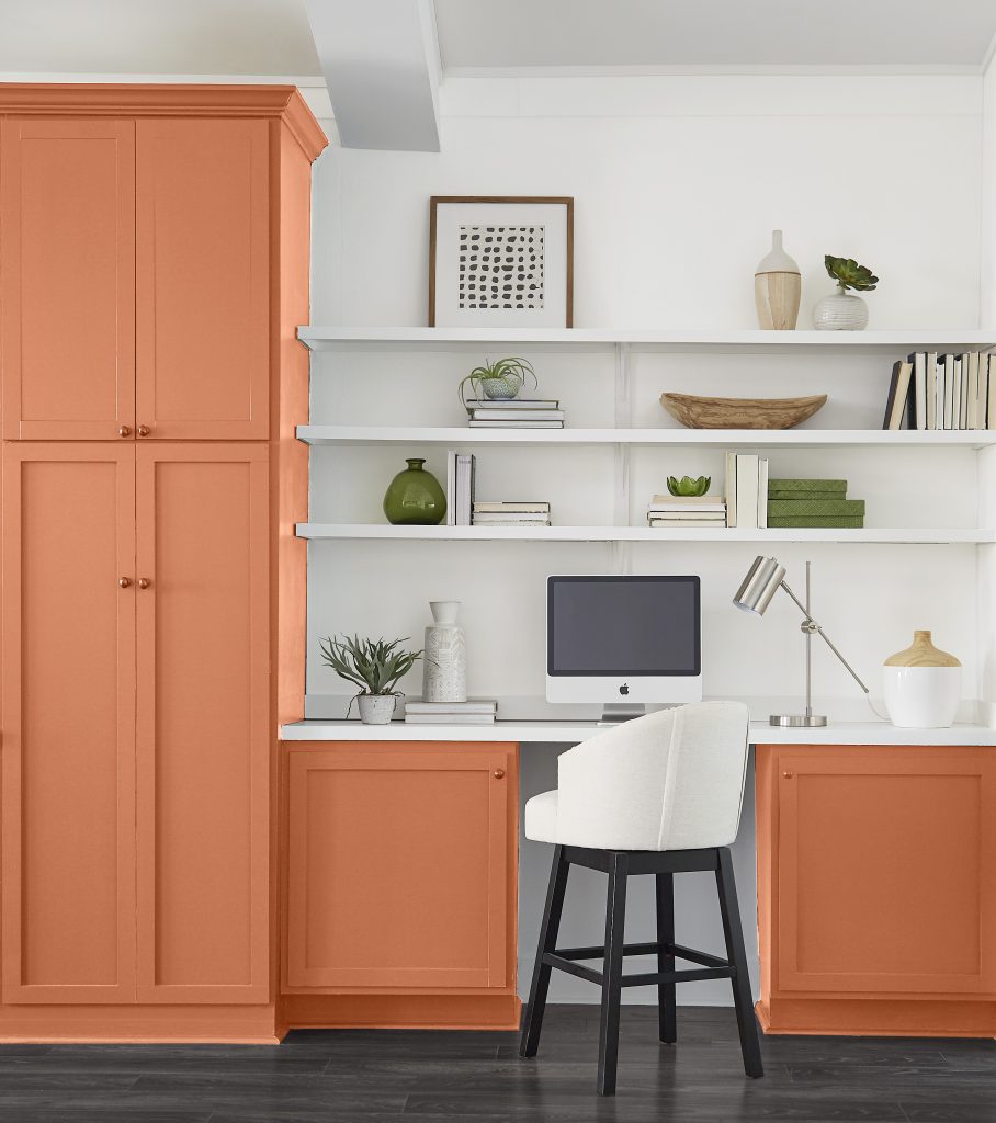 An office with the cabinets painted in a bold orange.