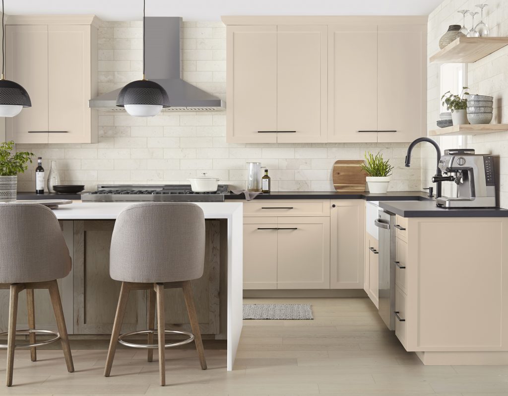 A kitchen with light tan cabinets.