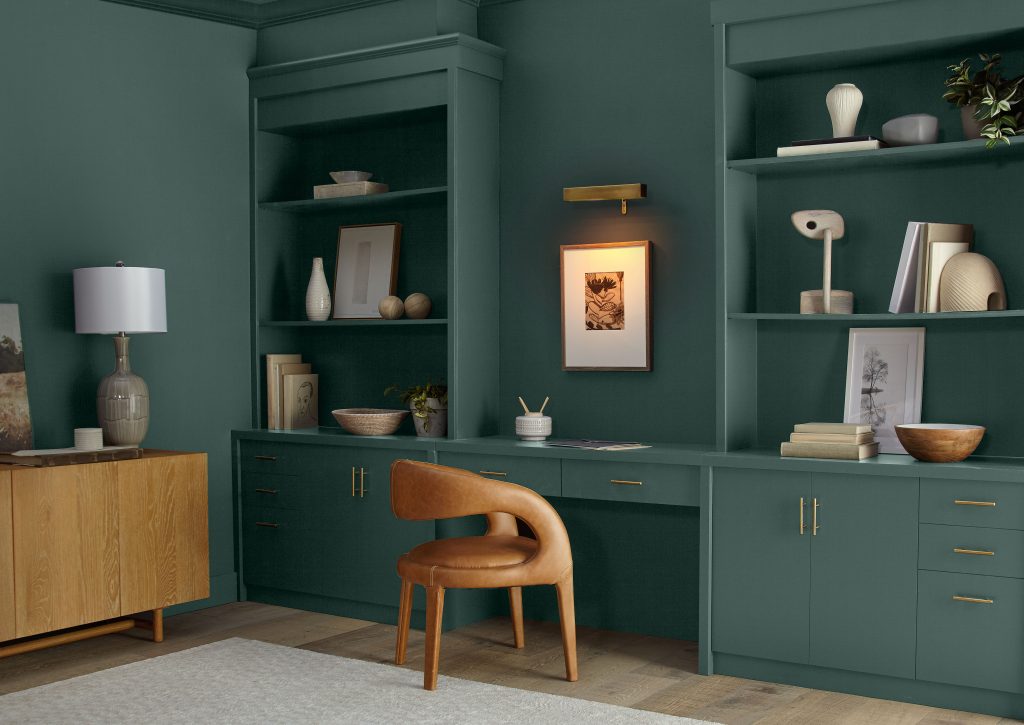 An office with a deep, rich green hue on the walls.