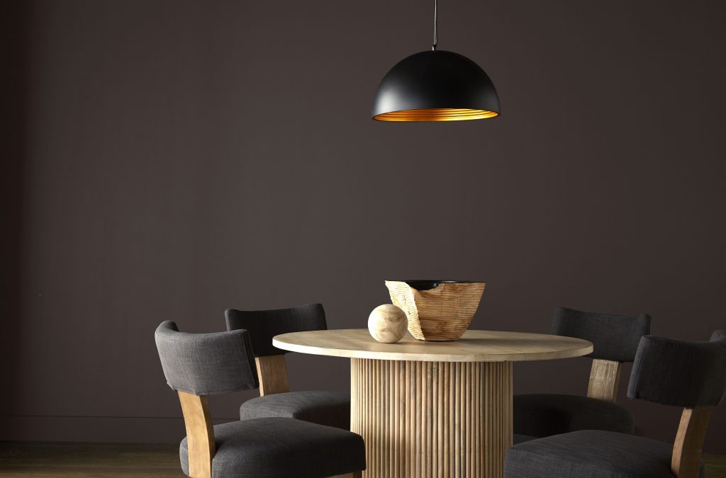 A dining area with rich brown painted walls.