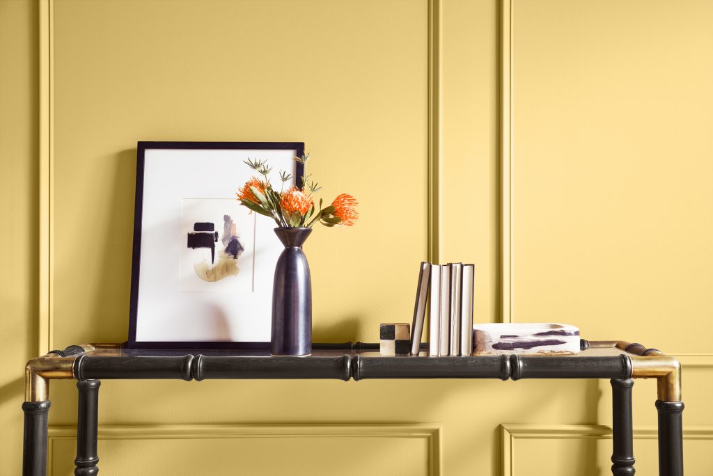 A bright hallway with the wall in a sunglow yellow hue.