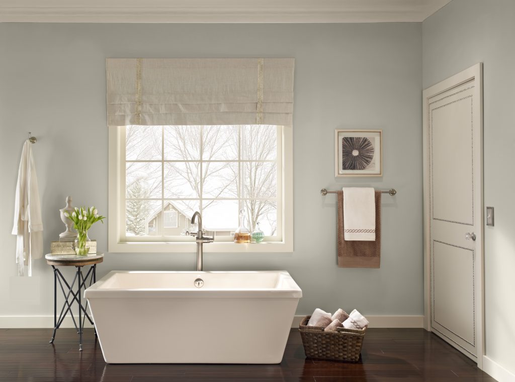 A bathroom with a soft and soothing gray hue painted on the walls.