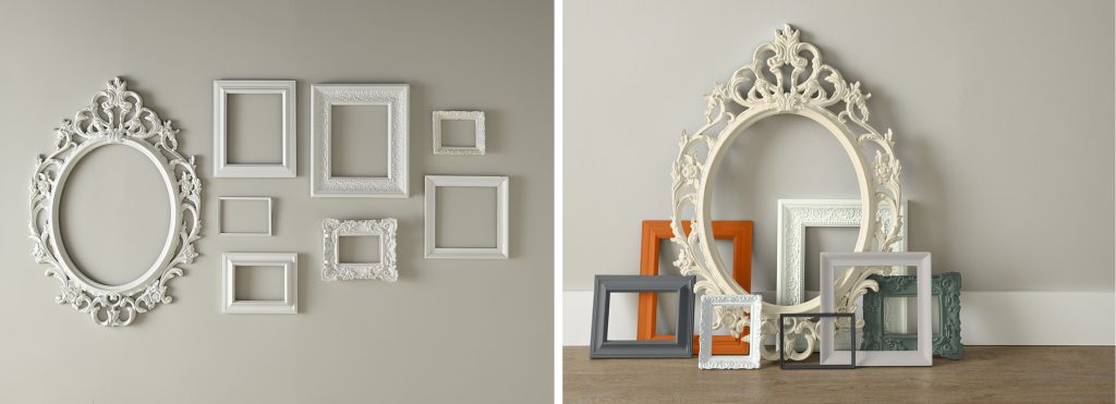Collection of ornate picture frames arranged on the floor and wall, featuring a mix of white, gray, green, and warm accent colors.