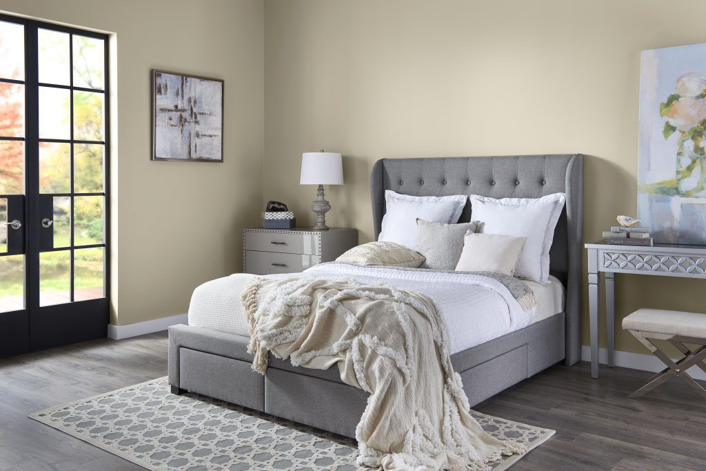 A bedroom with alls in a light neutral hue.