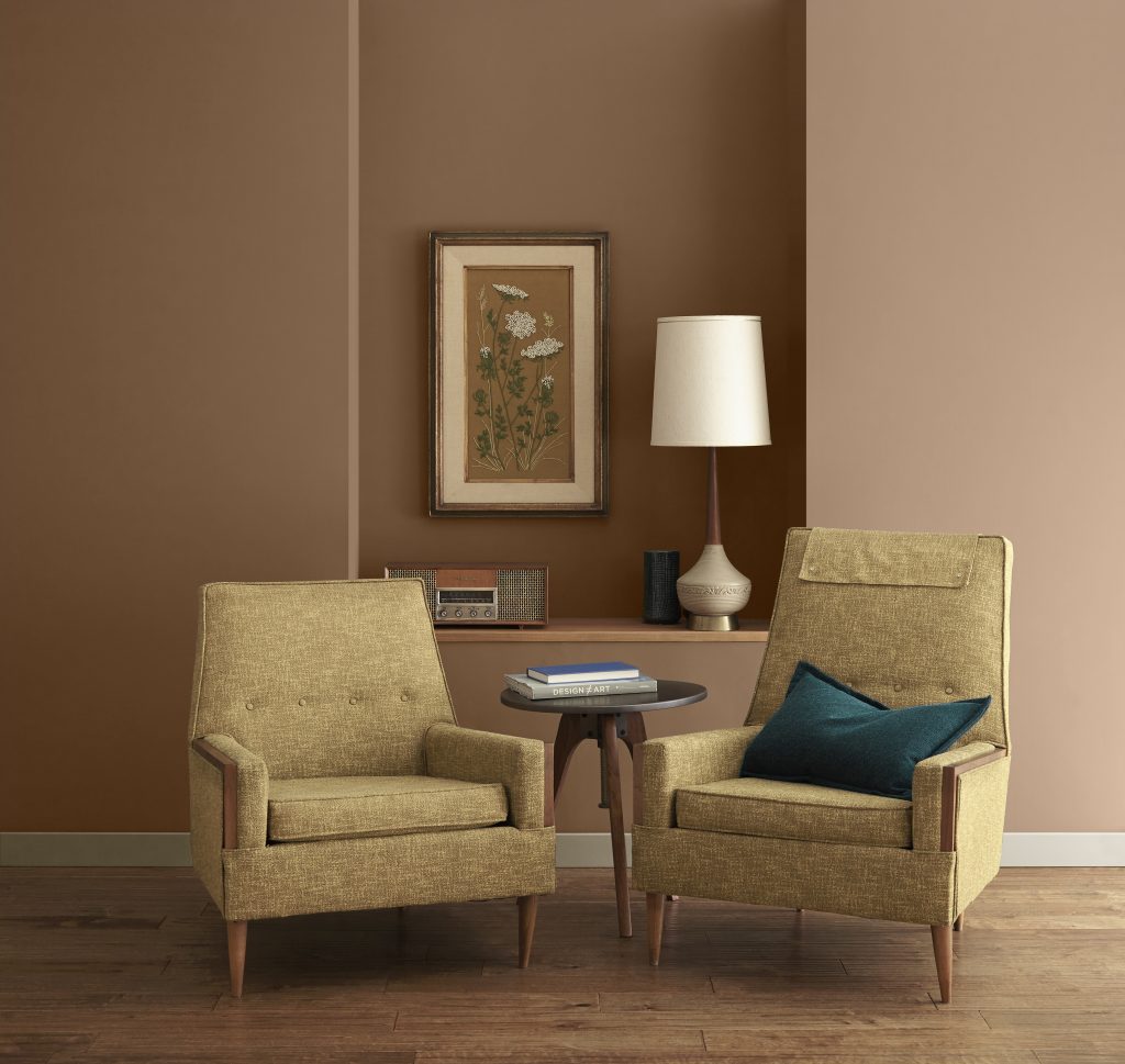 Cozy seating area with warm earthy brown walls and layered neutral textures.