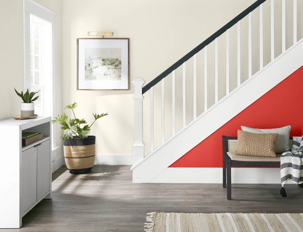 A stairway with a bold electric red accent and crisp white trim.