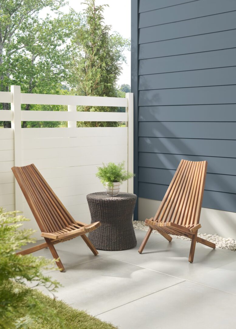 charming backyard scene with a soft blue-toned home contrasted by a light, neutral fence for a fresh, open feel.