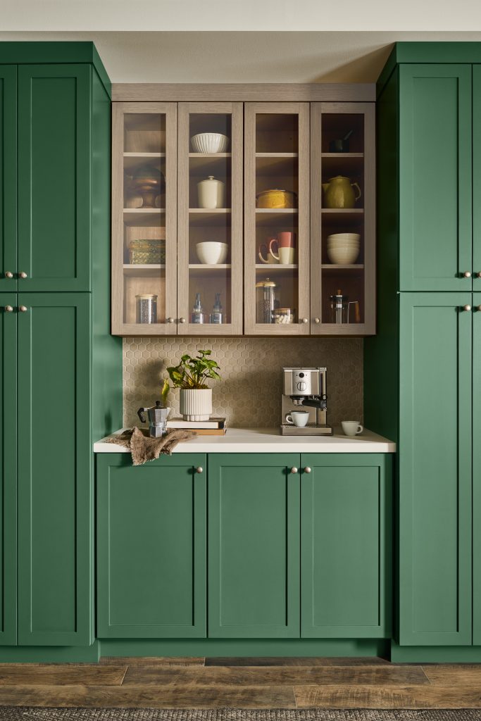 Kitchen with cabinets painted in a muted, earthy green.